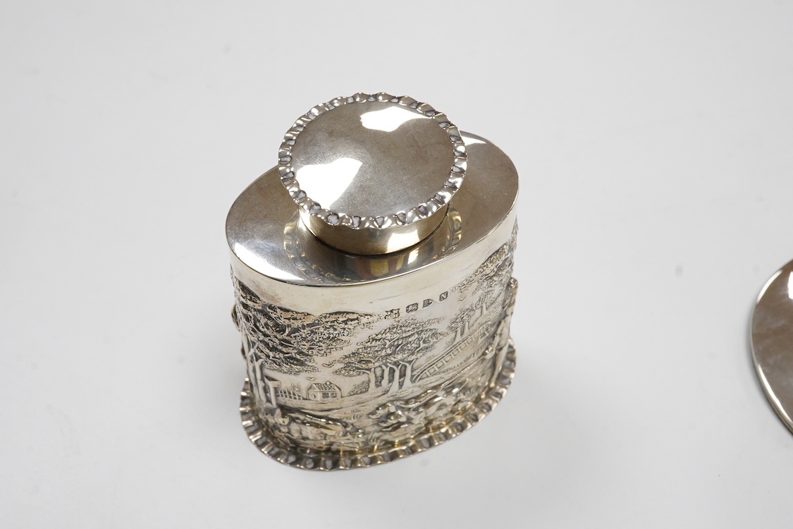 A late Victorian repousse silver oval tea caddy, by Nathan & Hayes, Chester, 1896, height 75mm, together with a George V silver mounted capstan inkwell.